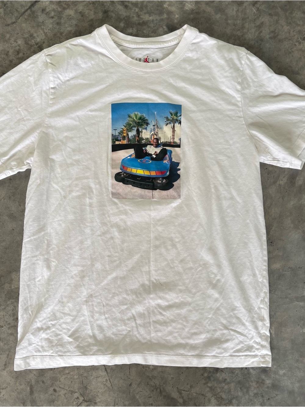 Jordan white graphic tee with Michael Jordan in a bumper car.